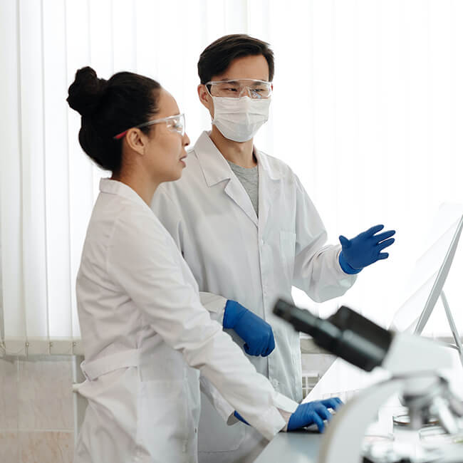 Two scientists discussing genotyping services