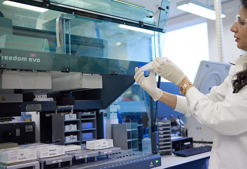 A laboratory scientist in a a laboratory using a device to conduct genome profiling for plants and enrichment of genic sequences